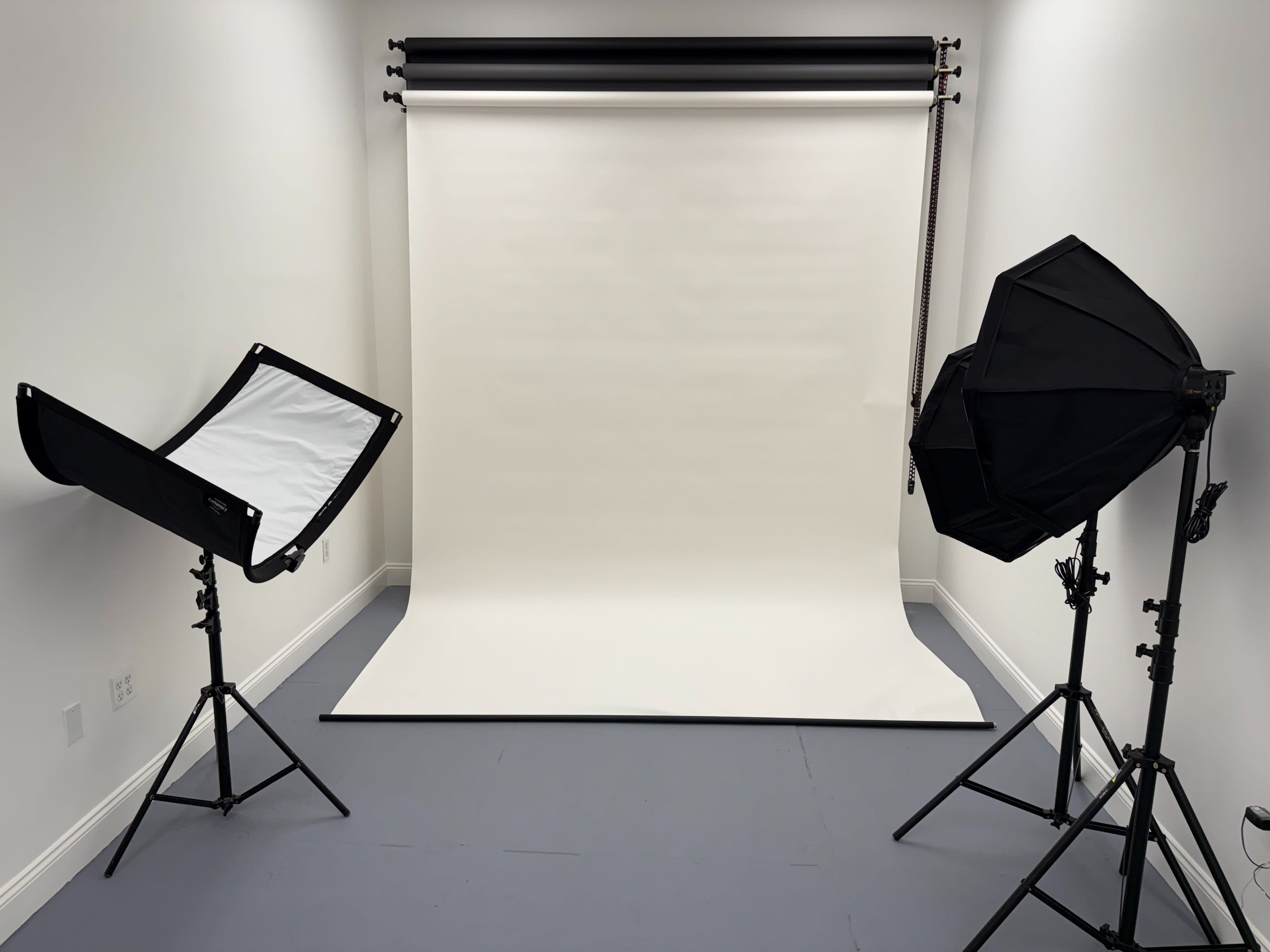 A photographer captures the arrangement of desserts and drinks on a small table during a business photo shoot.