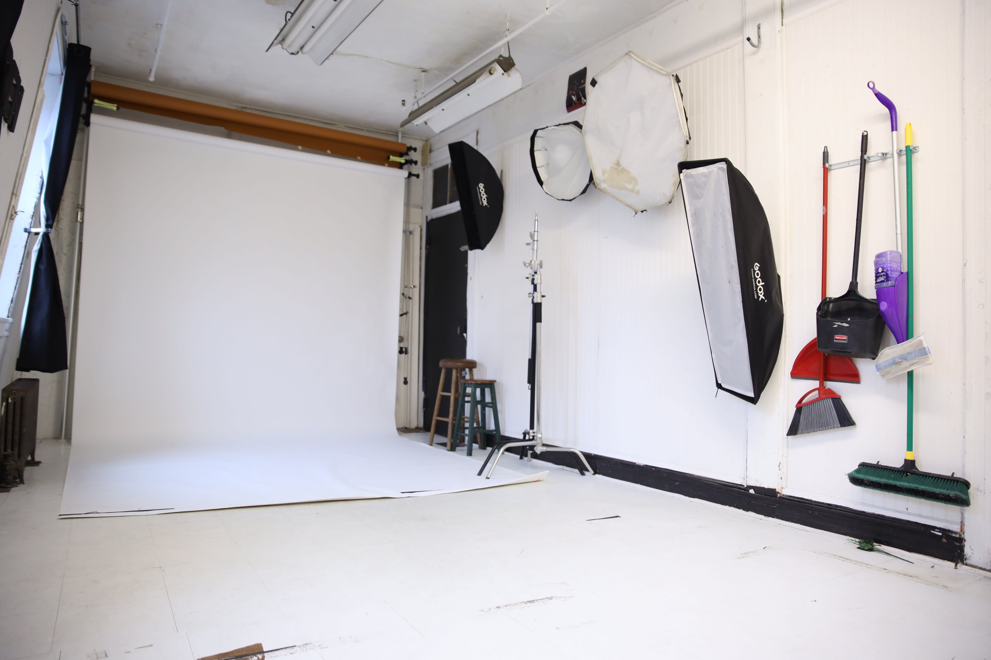 A young woman poses for a photoshoot against a plain white background.