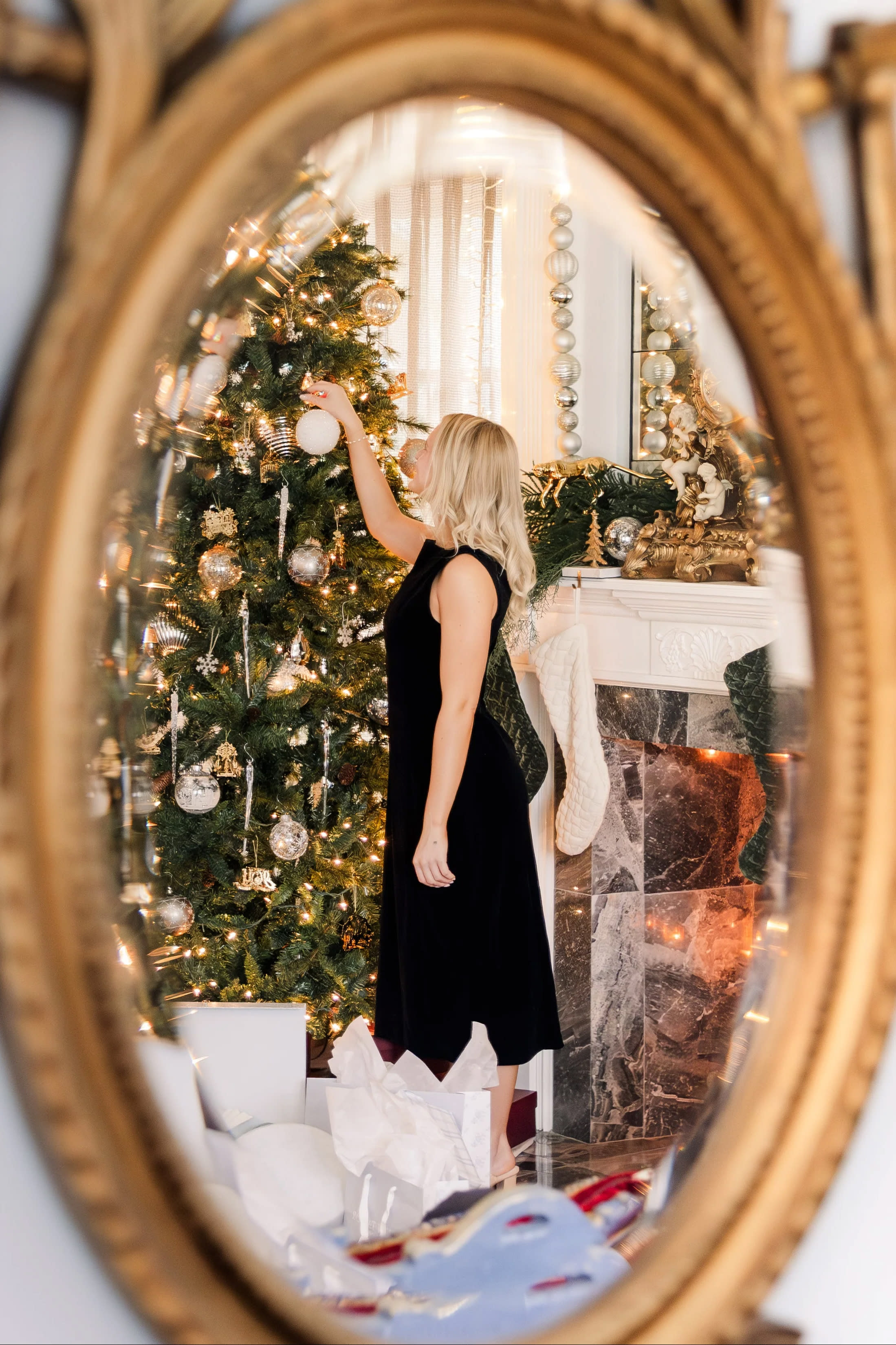 A model poses elegantly on a staircase adorned with festive decorations during a photography workshop.