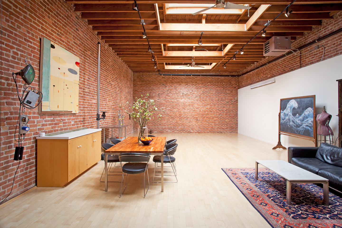 A string quartet is performing in a brick-walled rehearsal space.