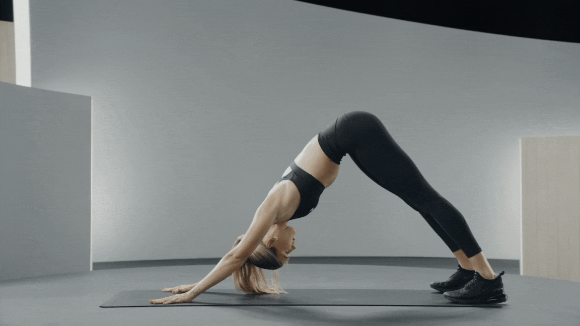 Peloton instructor Callie Gullickson demonstrates an articulating Downward Dog to high plank