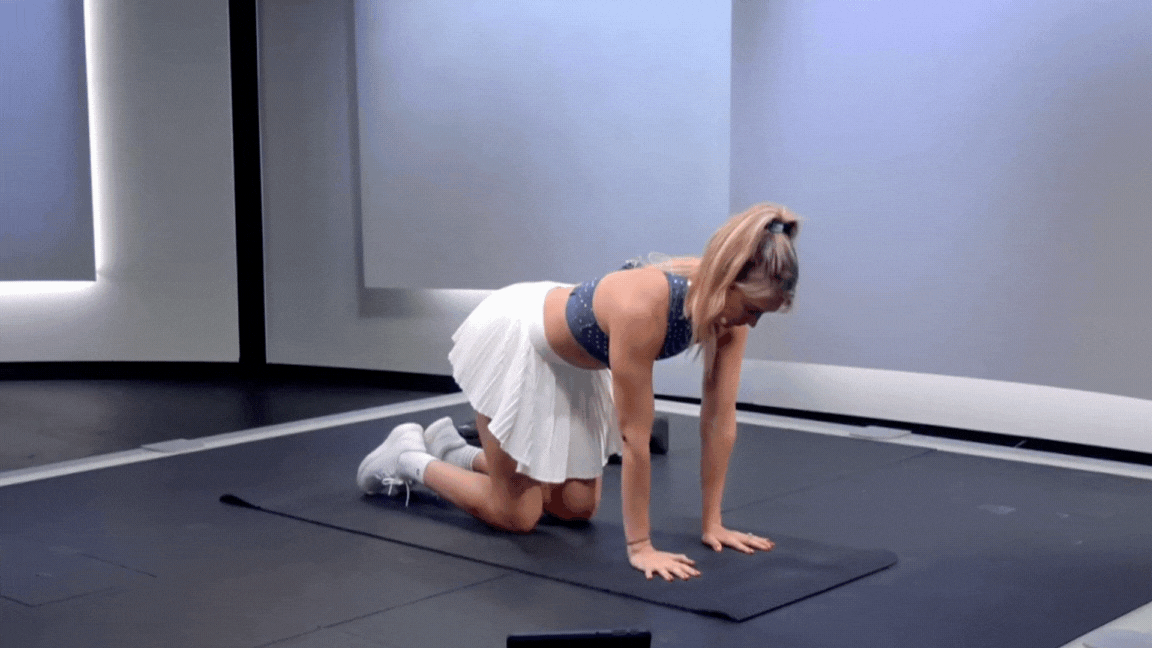 Peloton instructor Callie Gullickson demonstrates the bird dog exercise during a Peloton strength class.