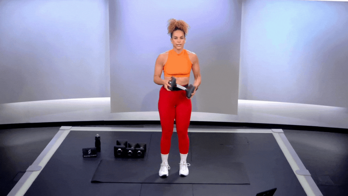 Peloton instructor Jess Sims demonstrates a reverse lunge woodchop as part of a strength training routine for basketball