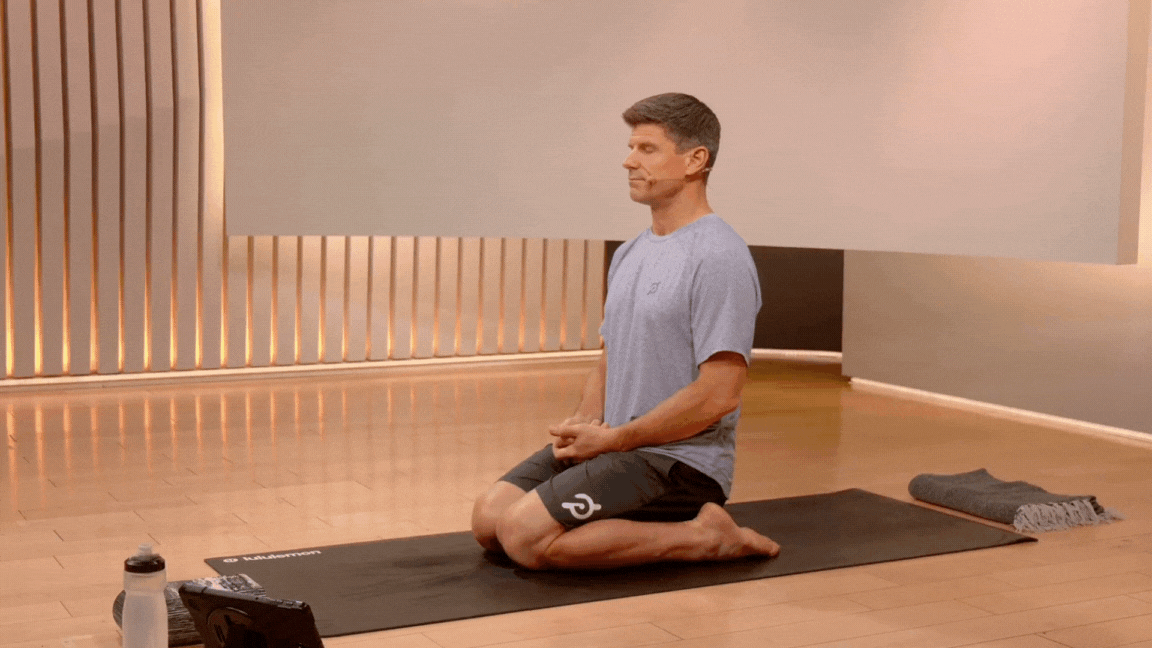 Peloton instructor Denis Morton takes a deep breath during a Peloton yoga class.