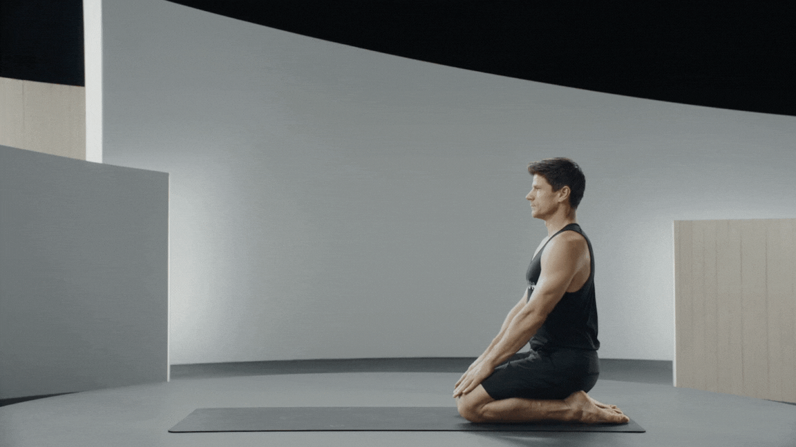 Peloton instructor Denis Morton demonstrates thread the needle stretch