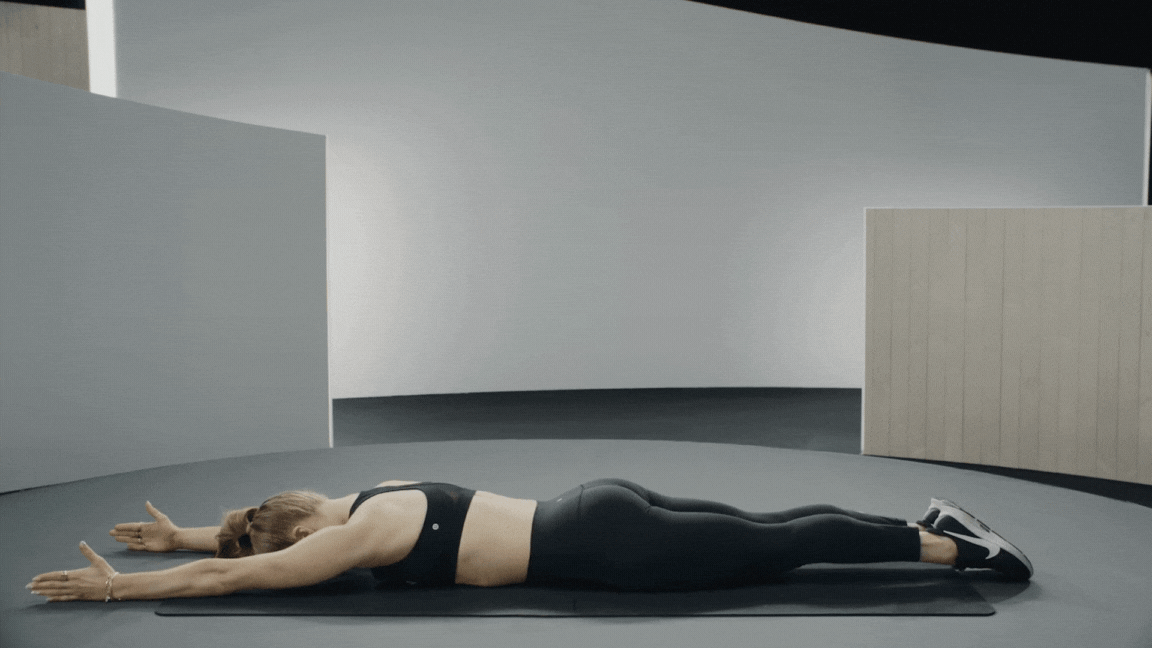 Peloton instructor Rebecca Kennedy demonstrates a superhuman hold bodyweight back exercise.