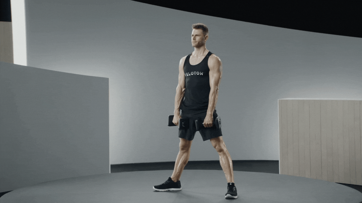 Peloton instructor Andy Speer demonstrates a dumbbell sumo deadlift.