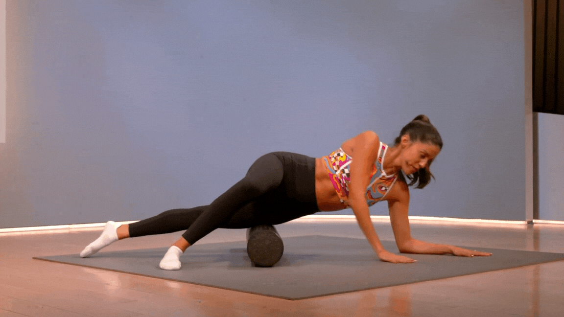 Woman demonstrates how to foam roll your IT band