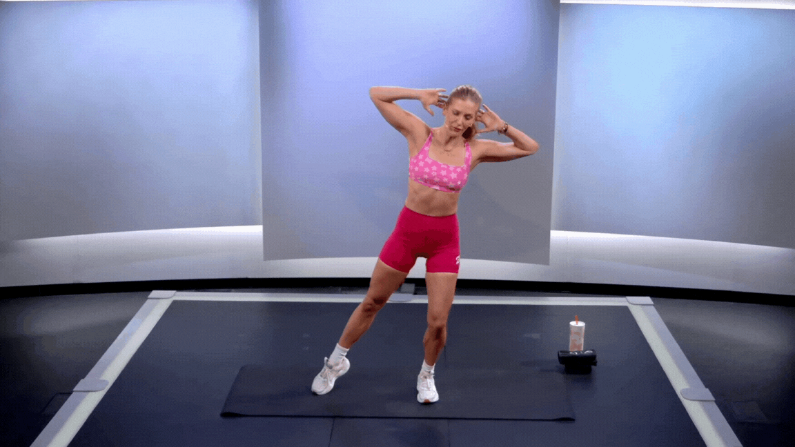 Peloton instructor Rebecca Kennedy demonstrates a standing lateral crunch core exercise