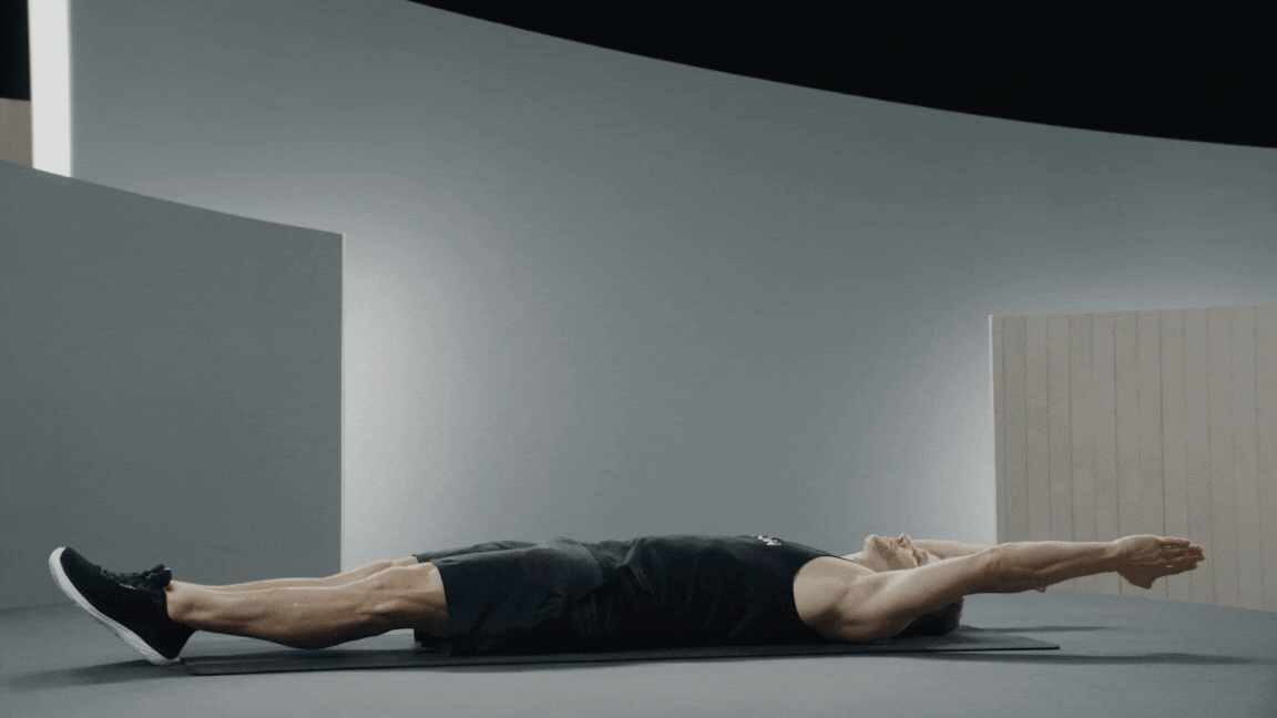Peloton instructor Andy Speer demonstrates a hollow body hold isometric exercise with proper form