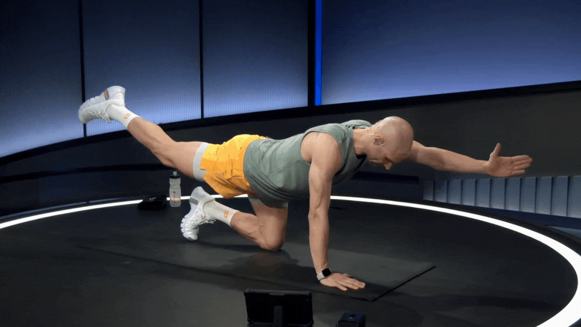 Peloton instructor demonstrates a bird dog hold isometric exercise during a Peloton core strength class