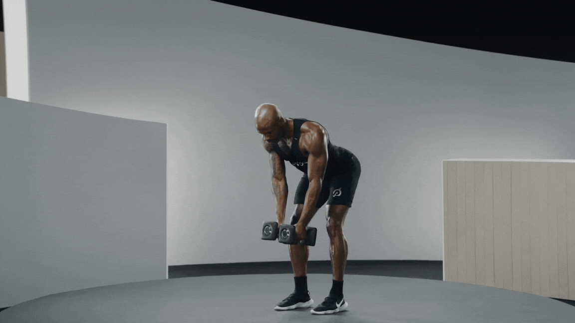 Peloton instructor Adrian Williams demonstrates a bent-over reverse fly rear deltoid exercise.