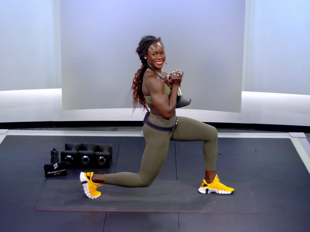 Pregnant woman doing exercises with dumbbells at home - a Royalty