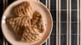 A plate of four grilled chicken breasts.