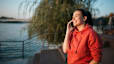 A woman habit stacking by talking on the phone and walking outside at the same time.