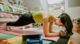 Woman practices plank exercise at home 