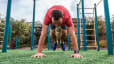 Man does a burpee exercise outdoors