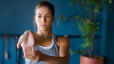 Woman performs a wrist stretch