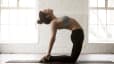 Woman doing Camel Pose on yoga mat