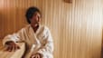 A woman relaxing in the sauna after a workout.