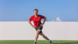 Man practices a curtsy lunge exercise outdoors 