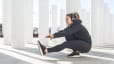 Woman practices a single leg or pistol squat 