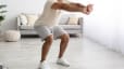 A close-up photo of a man's knees while engaging in a squat.