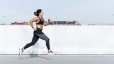 Woman does sprints outside while doing interval training