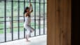 Photograph of woman doing Eagle Pose in yoga clothing