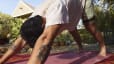 Peloton member doing downward dog, a yoga position