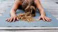 Woman practices Child's Pose (Balasana) in yoga