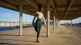 Woman doing Quad Stretch outside before going on run