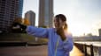 Woman shadowboxes outside on the river, what is shadowboxing