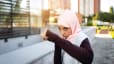 Woman boxes outside, showcases the benefits of boxing