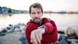 A man prioritizing his healthspan by stretching before exercising outside.