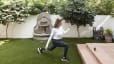 Woman does a walking lunge outdoors on grass