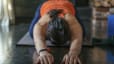 Woman practices Child's Pose, yoga for runners