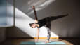 Woman practices half moon pose during a yoga practice