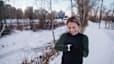 Woman checks her watch on a cold-weather run