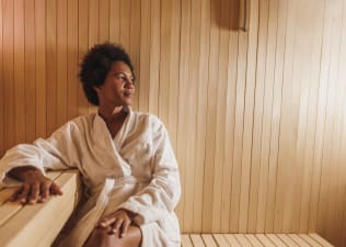 A woman relaxing in the sauna after a workout. 