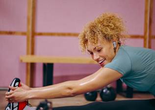 Happy woman completes a feel good workout with Peloton