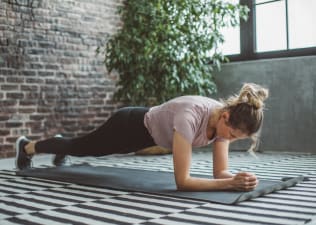 Woman does a forearm plank, 1-minute plank every day