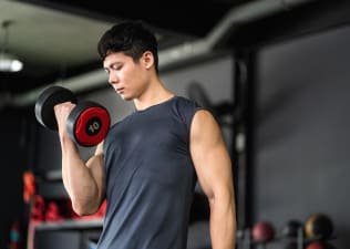 Man does a bicep curl exercise with a dumbbell