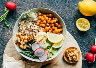 A nourishing bowl of food with plant-based protein sources like quinoa and chickpeas.