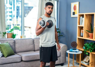 Man lifts weight at home