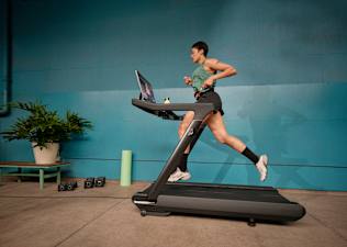 Person doing speed work running on a Peloton treadmill