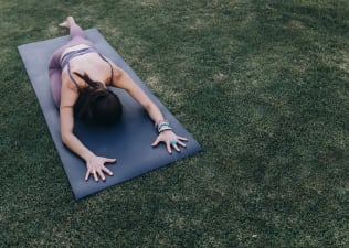 Woman does pigeon pose