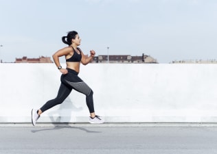 Woman does sprints outside while doing interval training