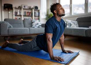 Man doing at-home yoga for his lower back.