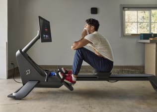 Man looks at his split time after finishing a rowing workout